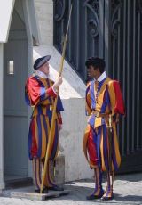 Two Papal Swiss Guards in traditional uniforms (yellow, orange, and red stripes). Photograph by Greatpatton of the French Wikipedia and used under the Creative Commons Attribution ShareAlike 1.0 license.